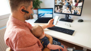 person working from home at computer with baby