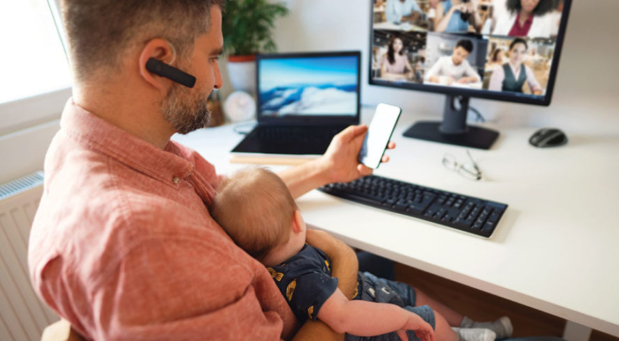 person working from home at computer with baby