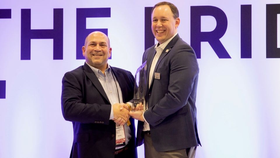 Brad Aikin, director of field marketing and training at Allegion, accepting the award with SIA NPS Committee Chair Christopher Grniet
