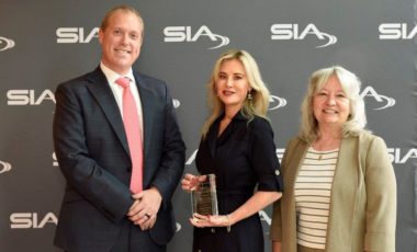 Delia McGarry accepting her award alongside SIA Women in Biometrics Awards presenters Benji Hutchinson and Cathy Tilton