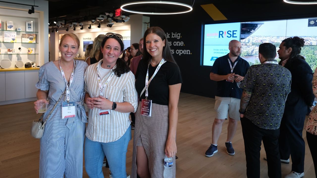 three young professionals at AcceleRISE 2024 conference