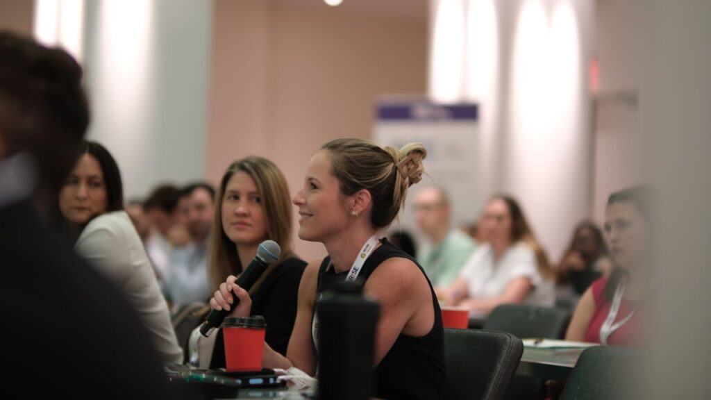 conference attendee asking a question at AcceleRISE 2024