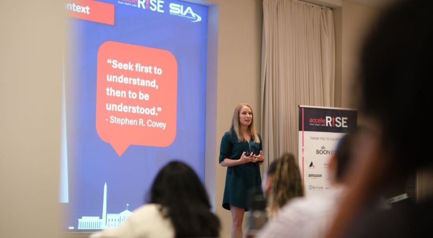 Kelly DeLeo on stage speaking at AcceleRISE 2024
