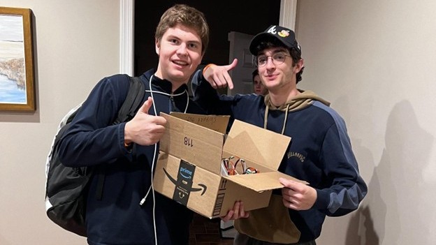 Co-founders Garrison and Jack holding a box of early sensors